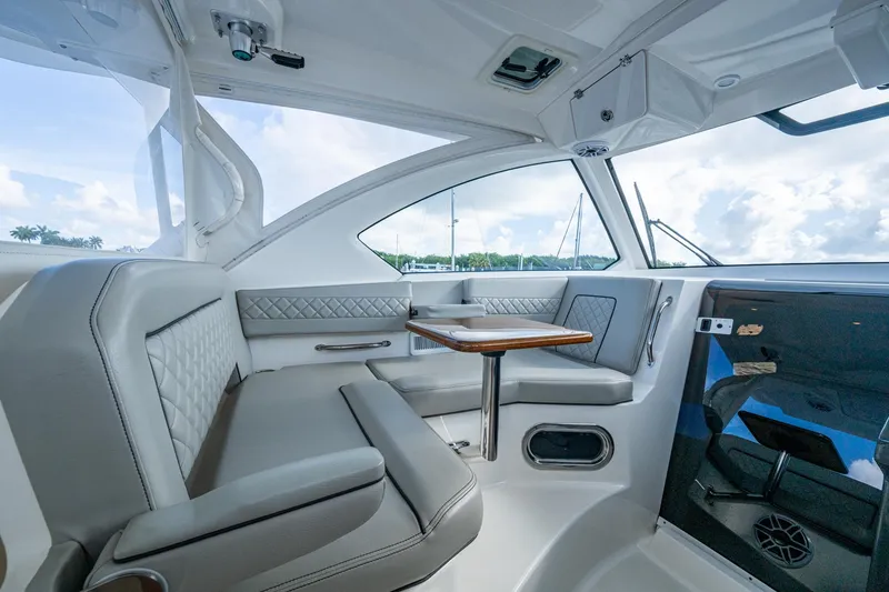 Slide: The Image of Interior of 2022 Pursuit OS 355 Offshore boat with elegant seating and table. - 34
