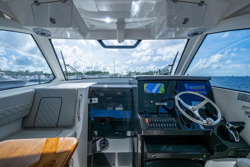 Slide: The Image of 2022 Pursuit OS 355 Offshore boat cockpit with modern navigation system and ocean view. - 36