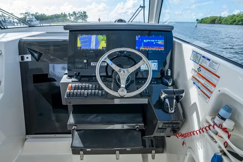 Slide: The Image of 2022 Pursuit OS 355 Offshore helm with advanced navigation displays and controls. - 39