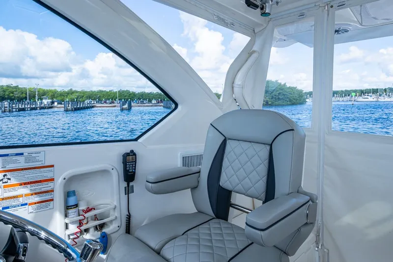 Slide: The Image of 2022 Pursuit OS 355 Offshore boat interior with luxurious seating and ocean view. - 40