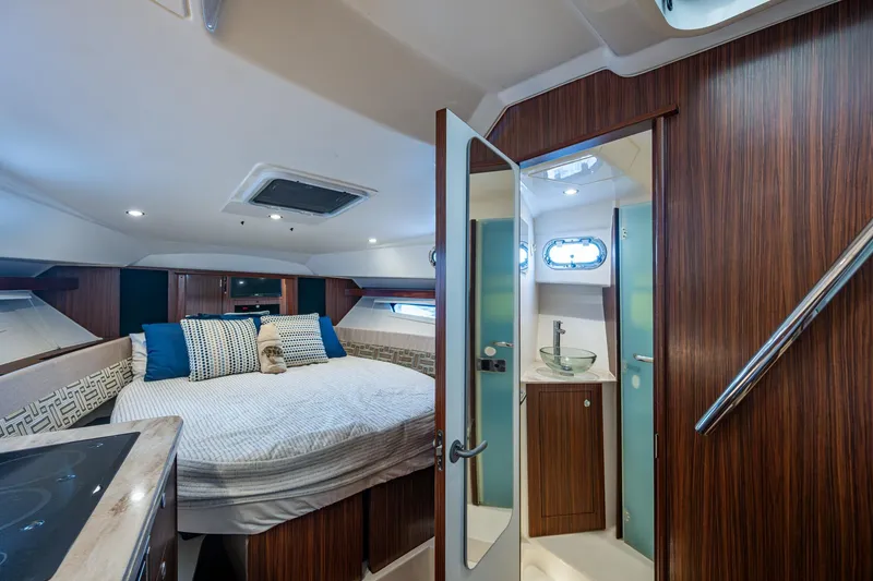 Slide: The Image of Luxurious cabin interior of 2022 Pursuit OS 355 Offshore boat with cozy bed and modern amenities. - 44