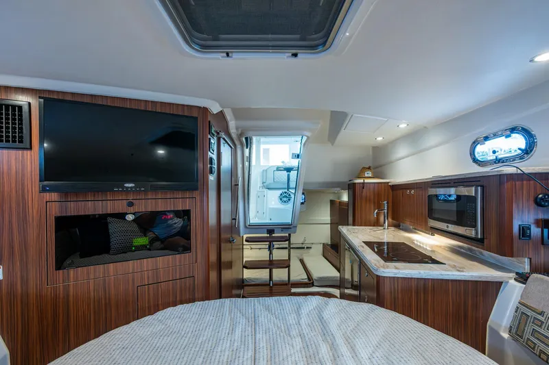 Slide: The Image of Luxurious cabin interior of 2022 Pursuit OS 355 Offshore with bed and bathroom. - 45