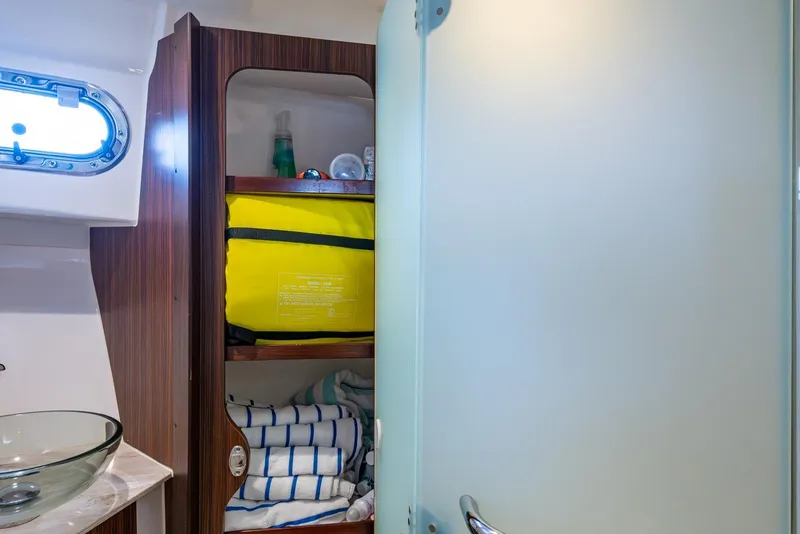 Slide: The Image of 2022 Pursuit OS 355 Offshore interior, featuring sleek white paneling and modern fixtures. - 54