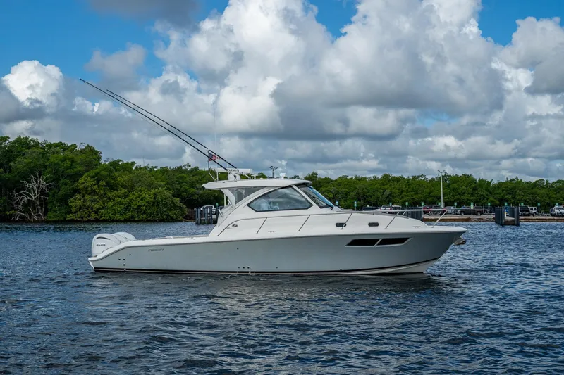 Slide: The Image of 2022 Pursuit OS 355 Offshore boat on water with cloudy sky background. - 7