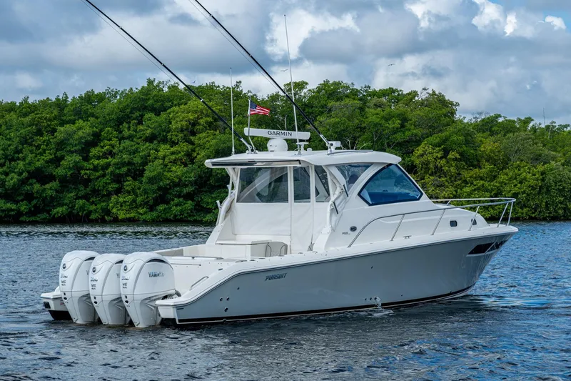 Slide: The Image of 2022 Pursuit OS 355 Offshore boat on water, featuring triple Yamaha engines. - 9