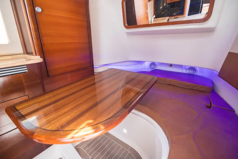 Slide: The Image of Luxurious interior of 2016 Edgewater 368CC boat with wooden table and ambient lighting. - 22