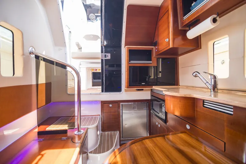 Slide: The Image of Luxurious interior of 2016 Edgewater 368CC boat with modern kitchen amenities. - 23