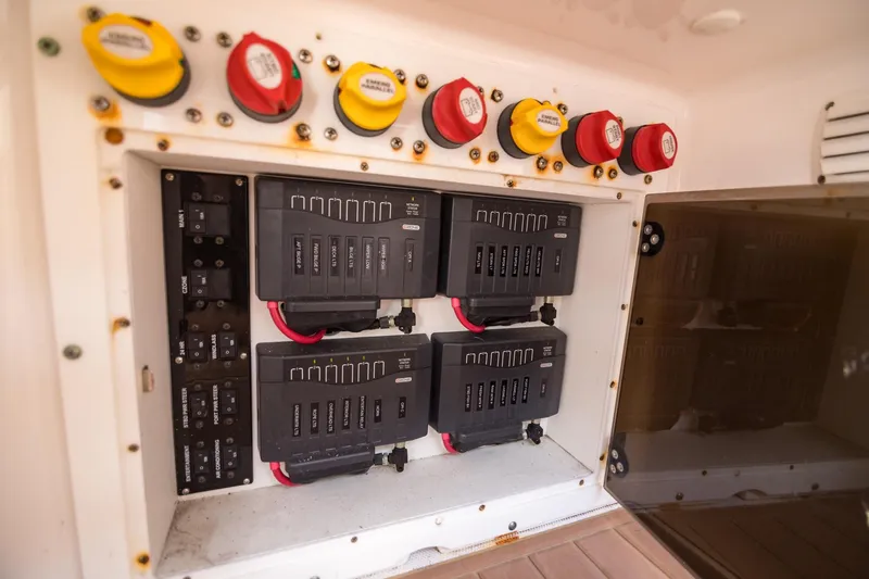 Slide: The Image of Electrical panel of a 2016 Edgewater 368CC boat, featuring circuit breakers and switches. - 28