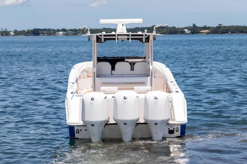 Slide: The Image of 2016 Edgewater 368CC boat with triple outboard engines on calm water. - 3