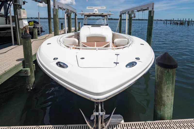 Slide: The Image of 2016 Edgewater 368CC boat docked at marina, showcasing sleek design and spacious deck. - 33