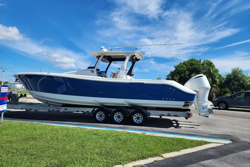 Slide: The Image of 2016 Edgewater 368CC boat on trailer under clear blue sky. - 37