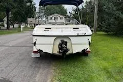 Slide: The Image of 2002 Chaparral 200 SSe boat parked on grass beside a road. - 10