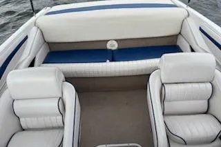Slide: The Image of 2002 Chaparral 200 SSe boat interior with white and blue seating on water. - 3