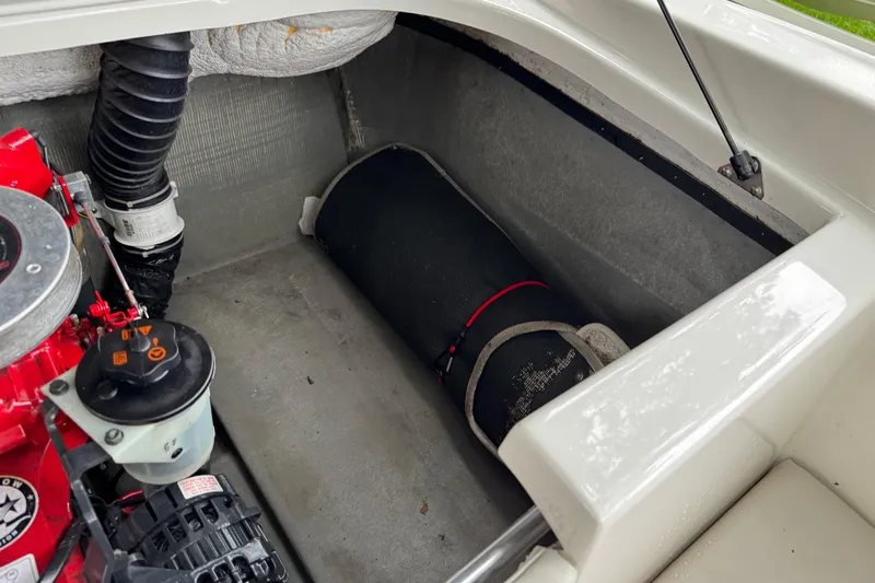 Slide: The Image of Engine compartment of a 1997 Seadoo Challenger boat, showing mechanical components and storage area. - 5