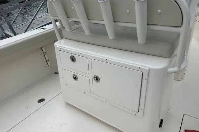 Slide: The Image of 2023 Cobia 240 Center Console boat storage area with rod holders and seating. - 12