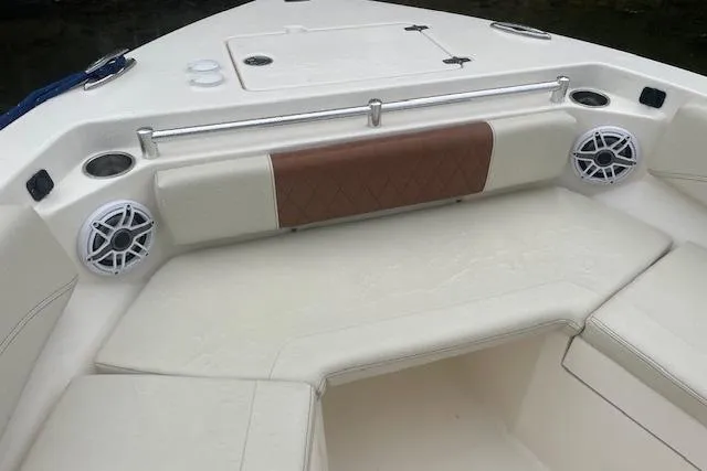 Slide: The Image of 2023 Cobia 240 Center Console boat interior with cushioned seating and speakers. - 14