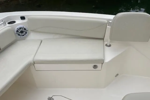 Slide: The Image of 2023 Cobia 240 Center Console boat interior with cushioned seating and speaker. - 16