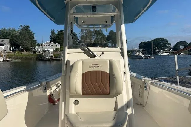 Slide: The Image of 2023 Cobia 240 Center Console boat on a serene waterfront setting. - 17