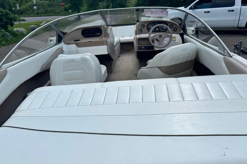 Slide: The Image of 2004 Regal 1800 LSR boat interior with white seating and dashboard view. - 3