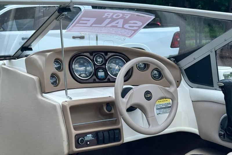 Slide: The Image of 2004 Regal 1800 LSR boat dashboard with steering wheel, gauges, and "For Sale" sign. - 6