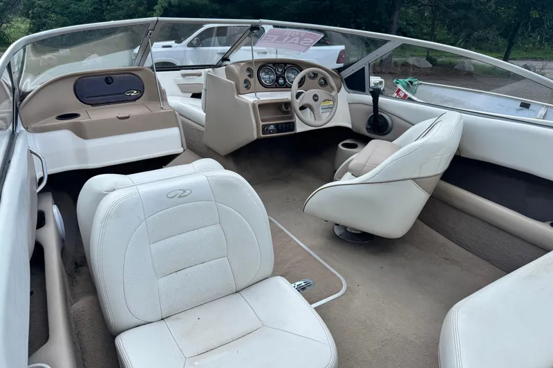 Slide: The Image of 2004 Regal 1800 LSR boat interior with white seating and dashboard, for sale sign visible. - 7