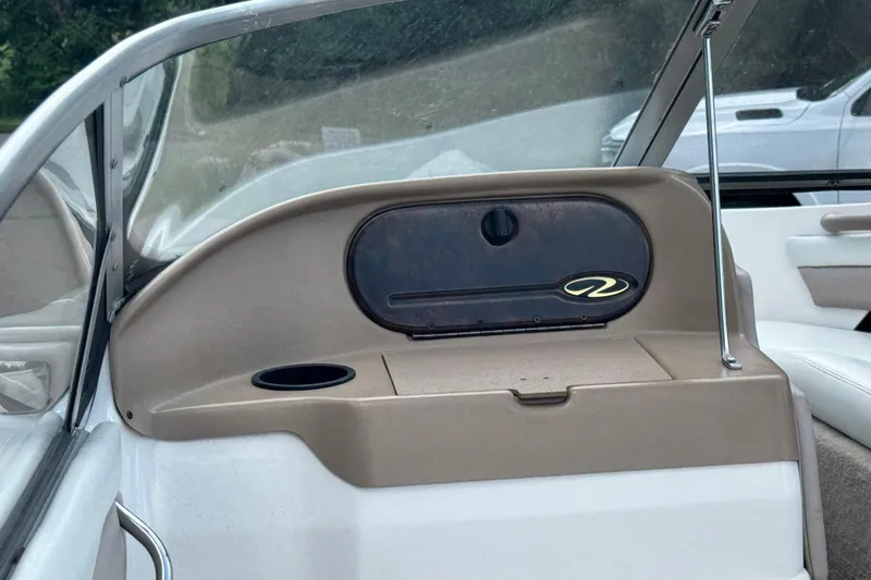 Slide: The Image of 2004 Regal 1800 LSR boat interior with dashboard and cup holder. - 8