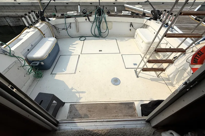 Slide: The Image of 1978 Bertram 42 Convertible boat deck with fishing gear and storage coolers. - 10