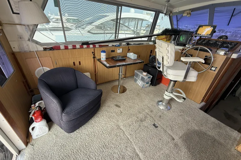 Slide: The Image of Interior of a 1978 Bertram 42 Convertible boat with helm and seating area. - 12