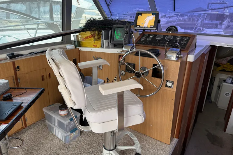 Slide: The Image of 1978 Bertram 42 Convertible helm with steering wheel, navigation equipment, and captain's chair. - 14