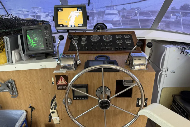 Slide: The Image of 1978 Bertram 42 Convertible helm with navigation equipment and steering wheel. - 15