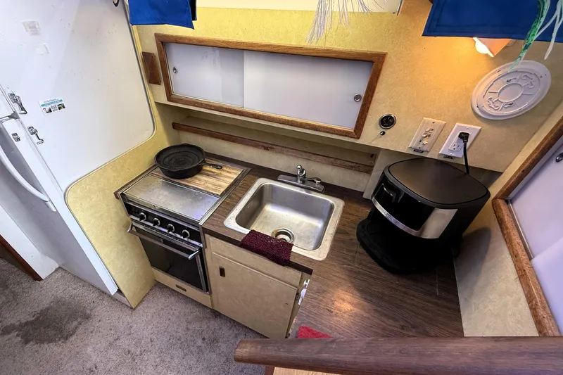 Slide: The Image of 1978 Bertram 42 Convertible kitchen with stove, sink, and coffee maker. - 17