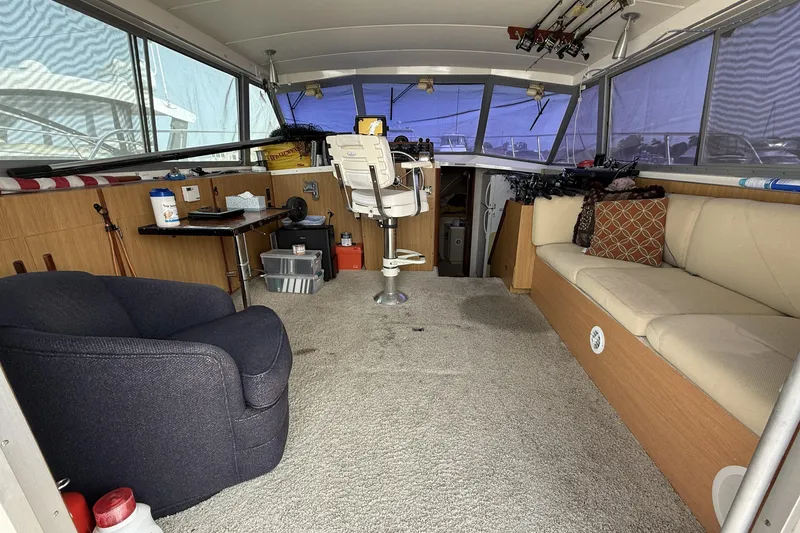 Slide: The Image of Interior of a 1978 Bertram 42 Convertible boat with seating and fishing gear. - 2