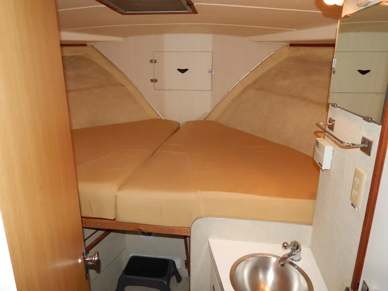 Slide: The Image of 1978 Bertram 42 Convertible cabin interior with twin beds and sink. - 20