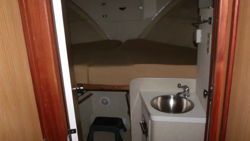 Slide: The Image of 1978 Bertram 42 Convertible cabin interior with bed and sink. - 21