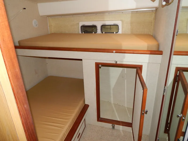 Slide: The Image of 1978 Bertram 42 Convertible cabin with bunk beds and storage cabinet. - 22