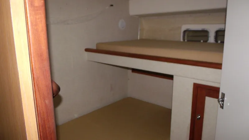 Slide: The Image of 1978 Bertram 42 Convertible cabin interior with bunk beds and wooden accents. - 23