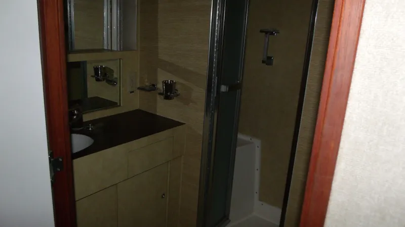 Slide: The Image of 1978 Bertram 42 Convertible bathroom with sink, mirror, and shower. - 27