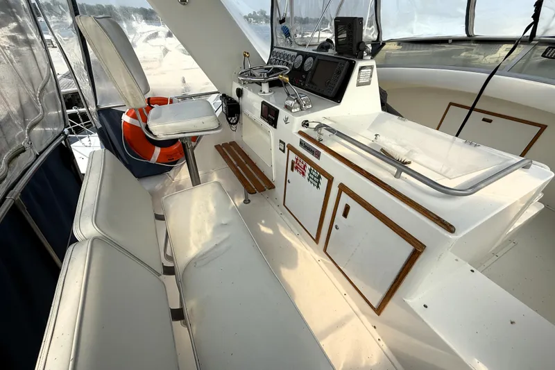 Slide: The Image of Interior of a 1978 Bertram 42 Convertible yacht with helm and seating area. - 29