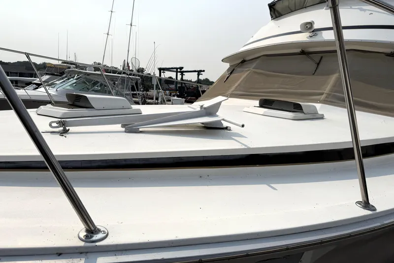 Slide: The Image of 1978 Bertram 42 Convertible yacht deck with anchor, docked at marina. - 31