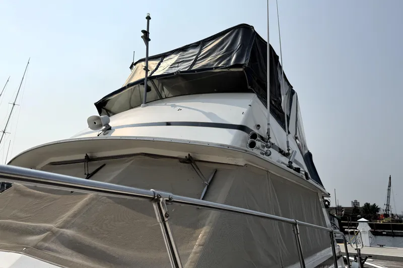 Slide: The Image of 1978 Bertram 42 Convertible yacht with covered flybridge, docked in a marina. - 32