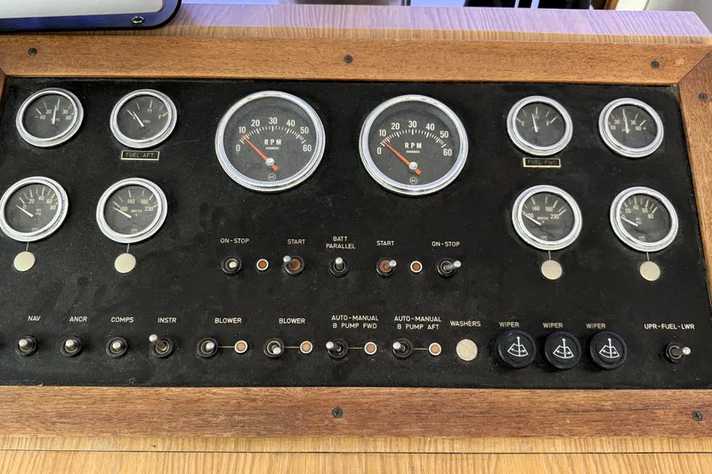 Slide: The Image of 1978 Bertram 42 Convertible dashboard with gauges and switches, featuring RPM and fuel indicators. - 33