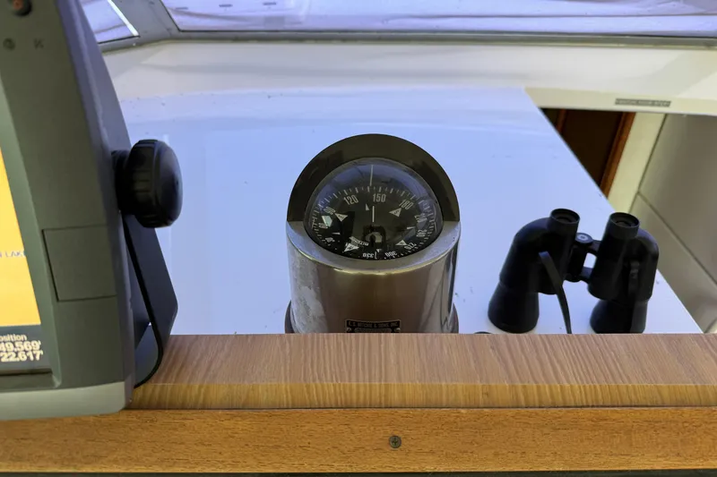 Slide: The Image of 1978 Bertram 42 Convertible helm with compass and binoculars on display. - 36