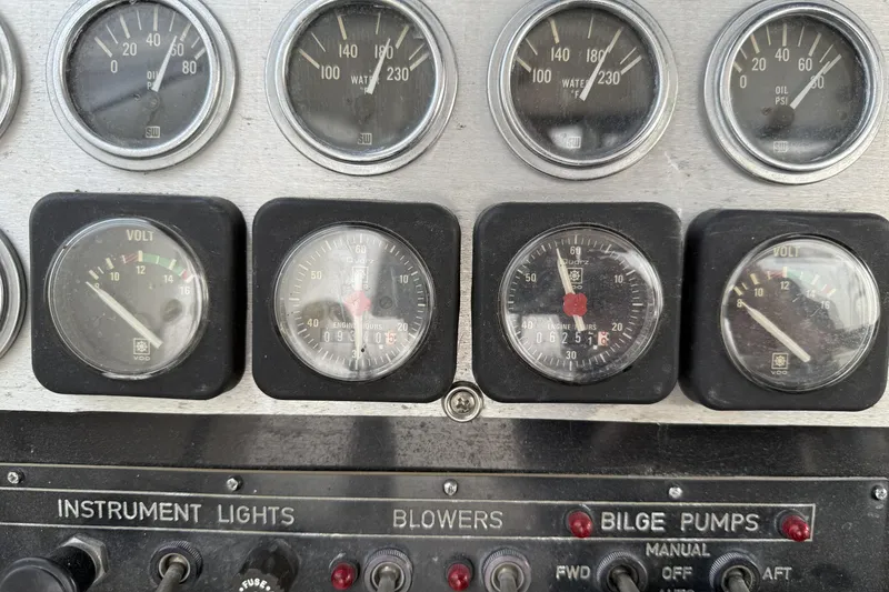 Slide: The Image of Dashboard of a 1978 Bertram 42 Convertible with gauges and switches for boat operation. - 38