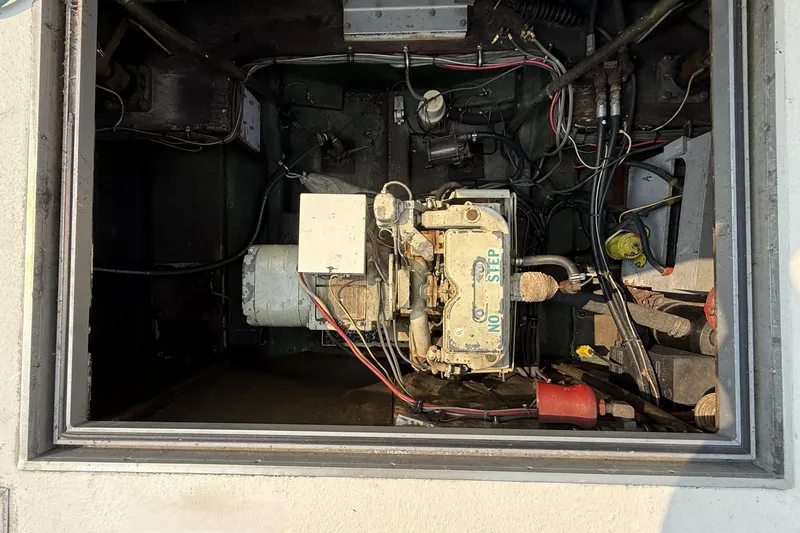 Slide: The Image of Engine compartment of a 1978 Bertram 42 Convertible boat, showing machinery and wiring. - 39