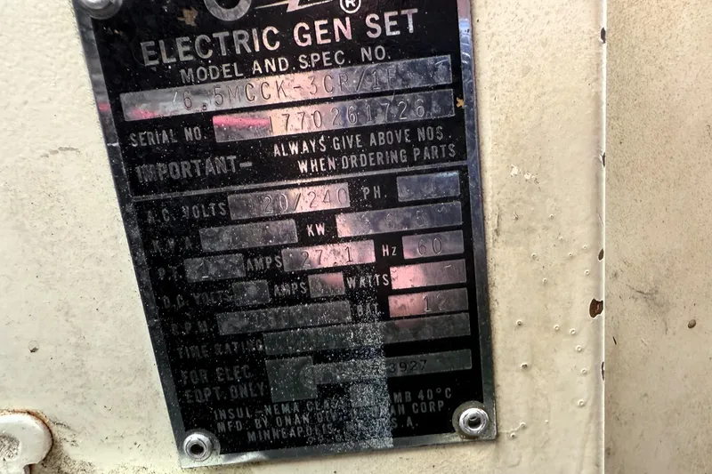 Slide: The Image of Close-up of a vintage electric generator specification plate on a 1978 Bertram 42 Convertible. - 40