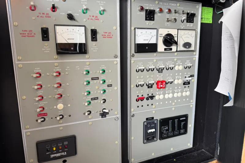 Slide: The Image of Control panel of a 1978 Bertram 42 Convertible boat with various switches and gauges. - 42
