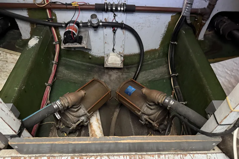 Slide: The Image of Engine compartment of a 1978 Bertram 42 Convertible boat, showing mechanical components and wiring. - 46