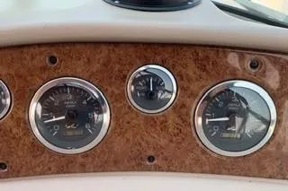 Slide: The Image of Dashboard of Sea Ray 340 Sundancer boat with analog gauges and wood finish. - 11