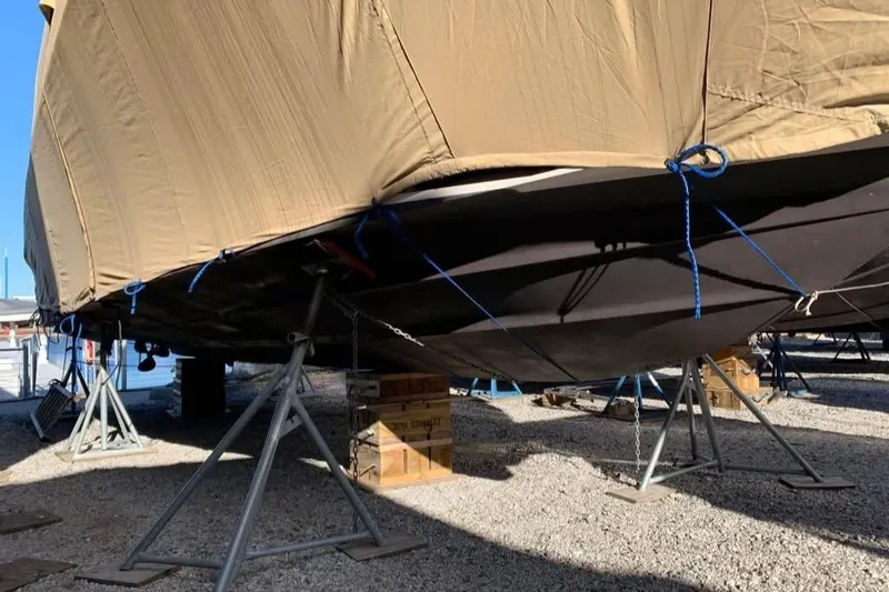 Slide: The Image of Covered 2000 Sea Ray 340 Sundancer boat on stands in a gravel yard. - 14
