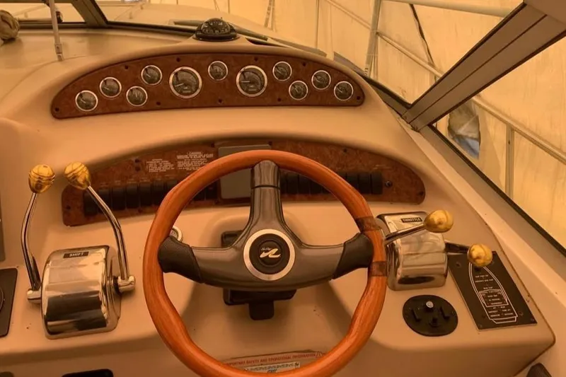 Slide: The Image of Steering wheel and controls of a 2000 Sea Ray 340 Sundancer boat. - 16
